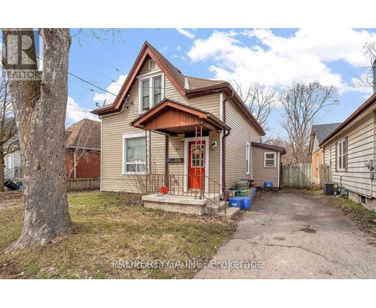 A house with a red door and a brown roof is for sale.