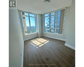 A room with a large window overlooking a cityscape.