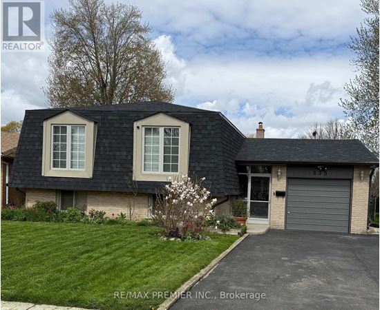 A house with a grey roof and a garage door is for sale.