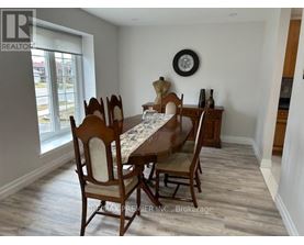 A dining room with a table set for six.