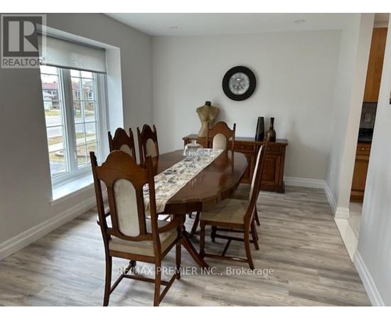 A dining room with a table set for six.