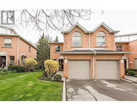 A large brick house with a driveway in front.