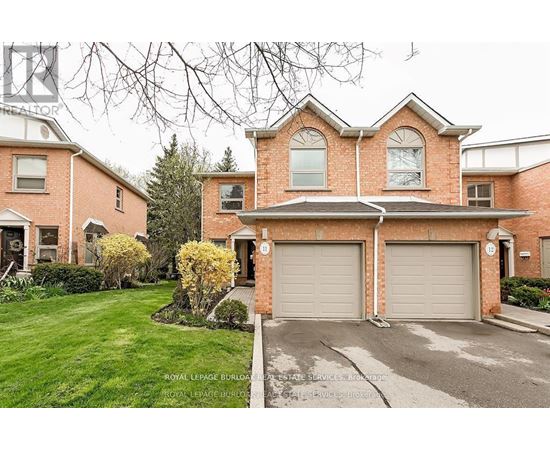 A large brick house with a driveway in front.