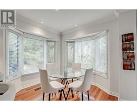 A dining room with a table and chairs.