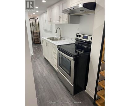 A modern kitchen with a black stove top oven.