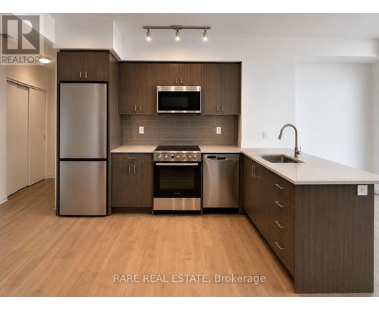 A modern kitchen with wooden cabinets and stainless steel appliances.