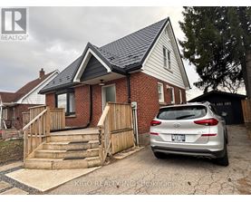 A house with a car parked in front of it.