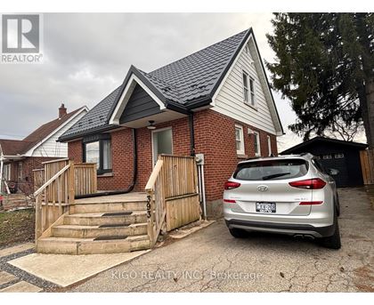 A house with a car parked in front of it.