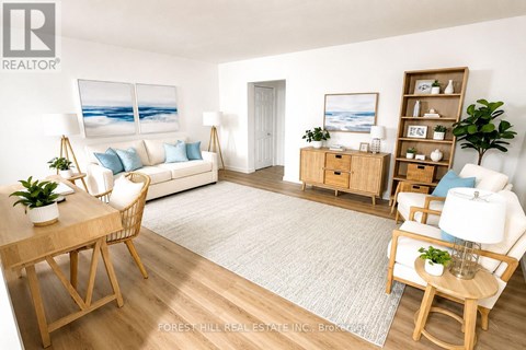A living room with a white couch, a wooden table, and a painting of a beach scene on the wall.