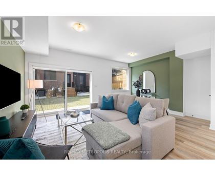 A living room with a couch, a chair, and a television.