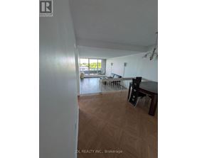 A room with a wooden floor and a table with chairs.