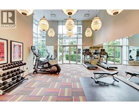 A gym with a variety of equipment including weights, treadmills, and exercise bikes.