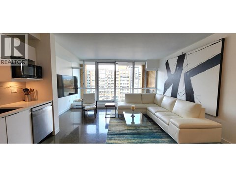 A modern living room with a large couch and a television.