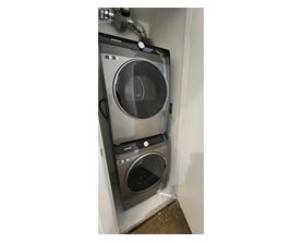 A washing machine and dryer are installed in a wall.