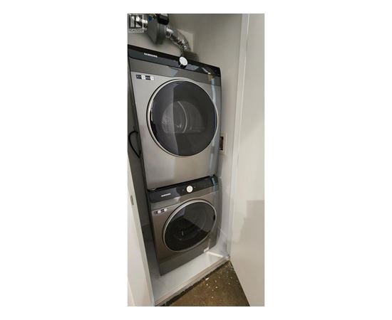 A washing machine and dryer are installed in a wall.