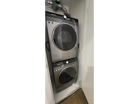 A washing machine and dryer are installed in a wall.
