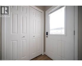 A white door with a window on the right side.