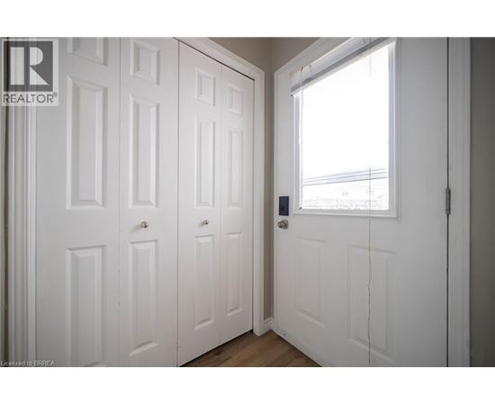 A white door with a window on the right side.