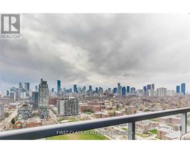 A cityscape with a cloudy sky and a building in the foreground.