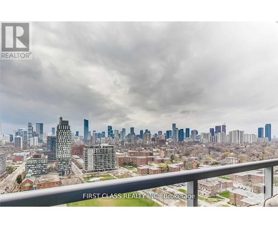 A cityscape with a cloudy sky and a building in the foreground.