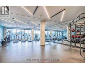 A gym with a variety of equipment including treadmills, weights, and exercise machines.