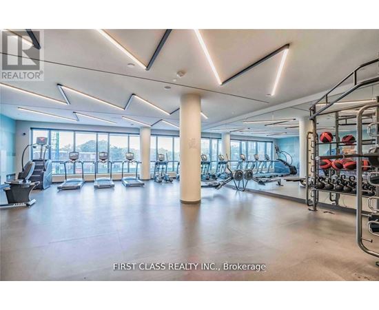 A gym with a variety of equipment including treadmills, weights, and exercise machines.