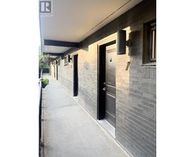 A building with a black door and a window with a white frame.
