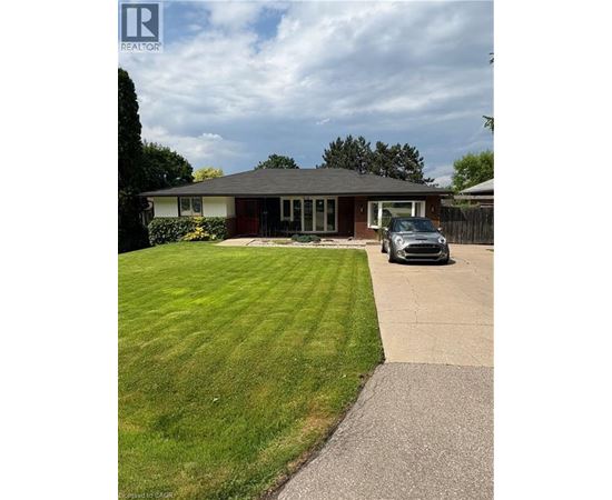 A house with a grey car parked in front.
