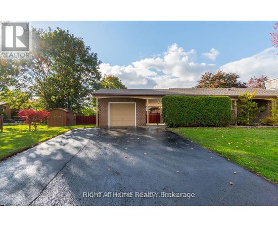 A house with a driveway and a garage door is for sale.