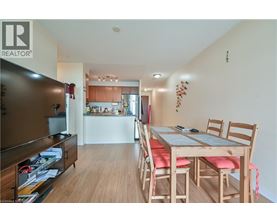 A dining room with a wooden table and chairs.