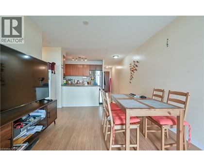 A dining room with a wooden table and chairs.