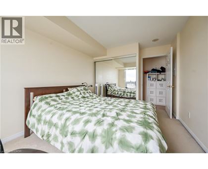A bedroom with a bed and a mirror on the wall.
