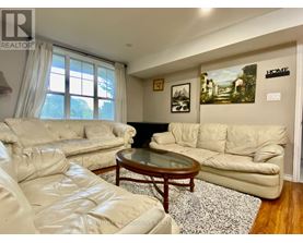 A living room with a white couch and a coffee table.