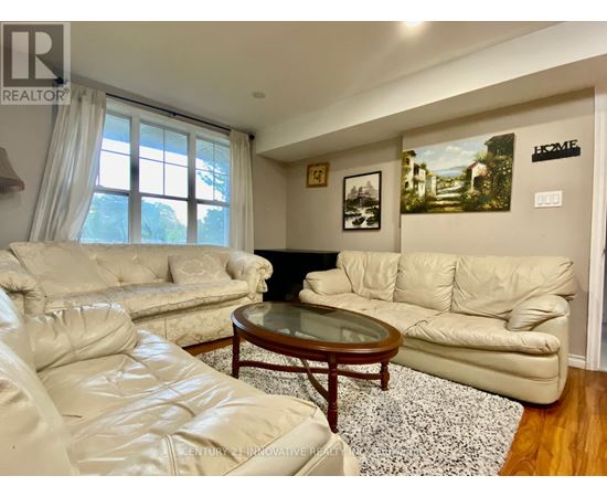 A living room with a white couch and a coffee table.