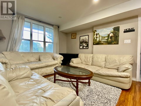 A living room with a white couch and a coffee table.