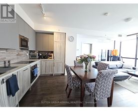 A modern kitchen with a dining table set for four.