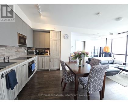A modern kitchen with a dining table set for four.