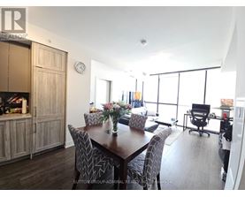 A dining room with a wooden table and chairs.