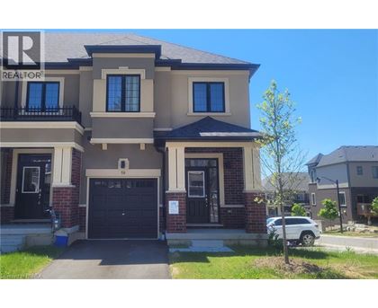 A two-story house with a garage and a balcony on the second floor.