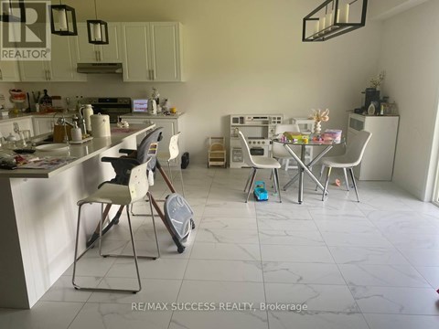 A kitchen with a dining table and chairs.