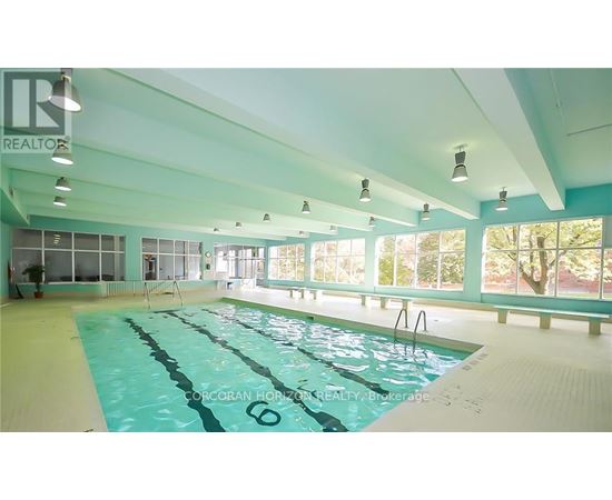 A large indoor swimming pool with the number 6 on the side.