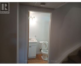 A bathroom with a toilet and sink is shown.