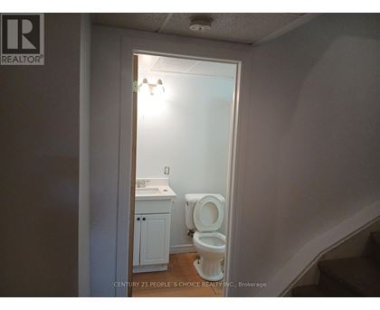 A bathroom with a toilet and sink is shown.