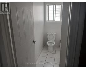 A bathroom with a toilet and a door.
