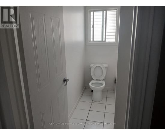 A bathroom with a toilet and a door.