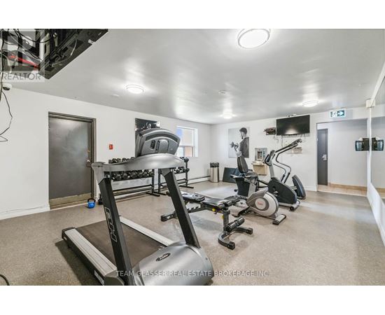 A spacious room with a treadmill, elliptical trainer, and stationary bike.