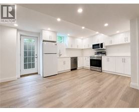 A spacious kitchen with white cabinets and appliances.