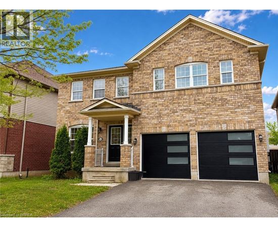 A brick house with a black garage door.