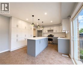A spacious kitchen with white cabinets and a central island.