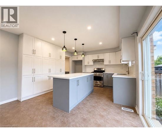 A spacious kitchen with white cabinets and a central island.